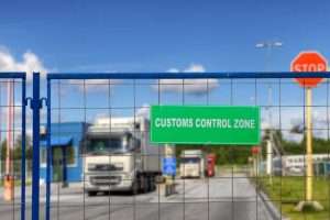 trucks pass through the checkpoint of the customs logistics terminal.