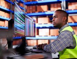 warehouse inventory management on computer. staff in office